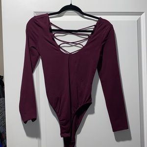 Purple body suit with open back detail